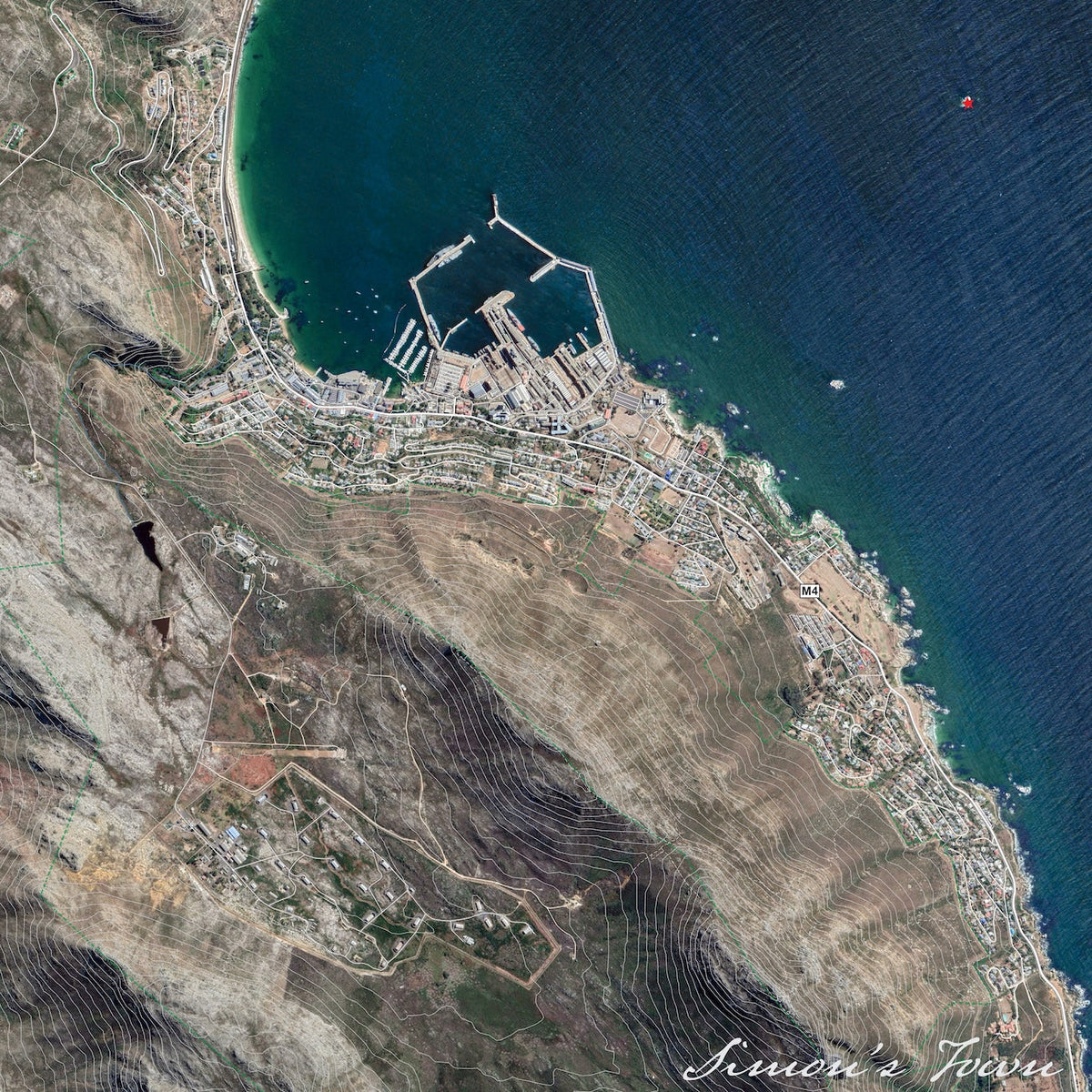 Simon's Town 2 aerial map print showing the harbour, naval dockyard and coastal town from above, with deep blue False Bay against dry contoured mountain slopes.