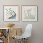Two framed classic maps of Kenton-on-Sea and Swellendam in dining setting, a table with white chair