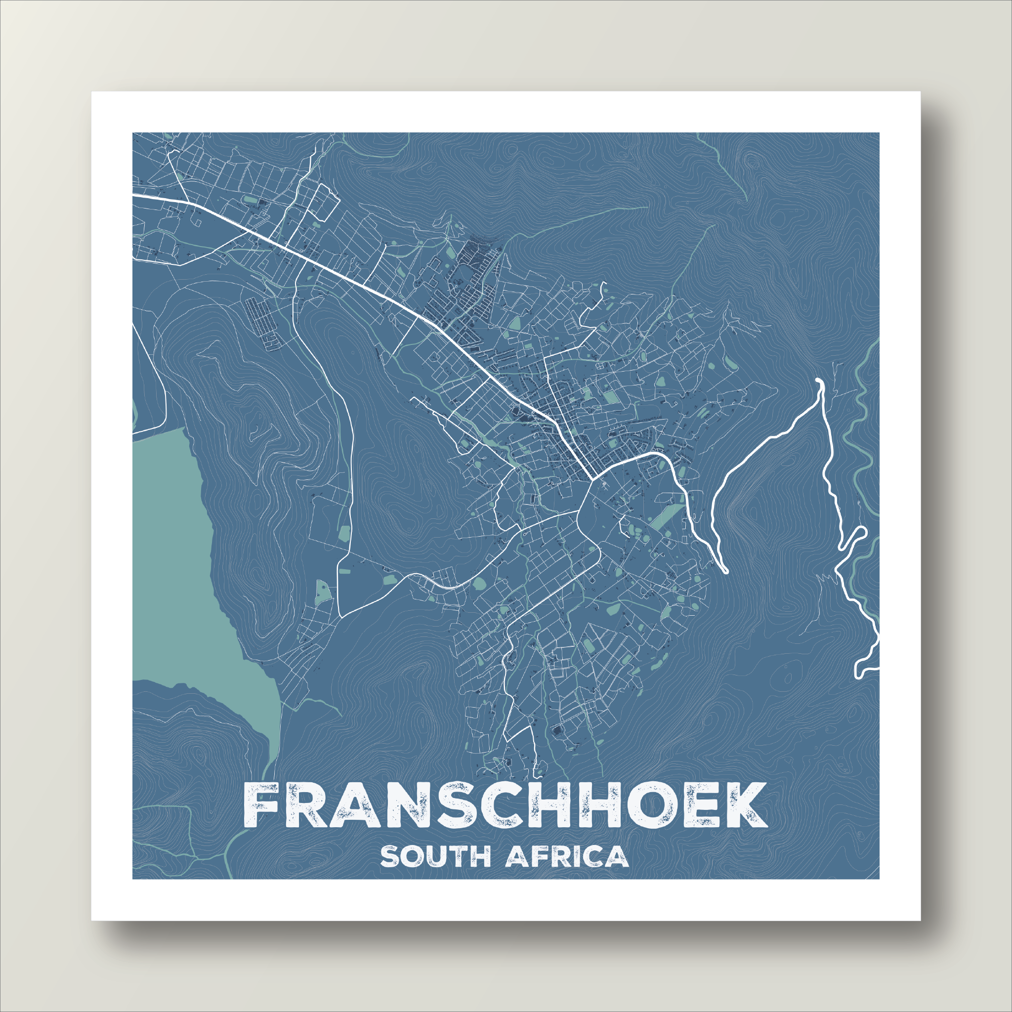 Franschhoek map print in the Kashmir Blue style, with white road network and pale green vineyards on a slate blue background.