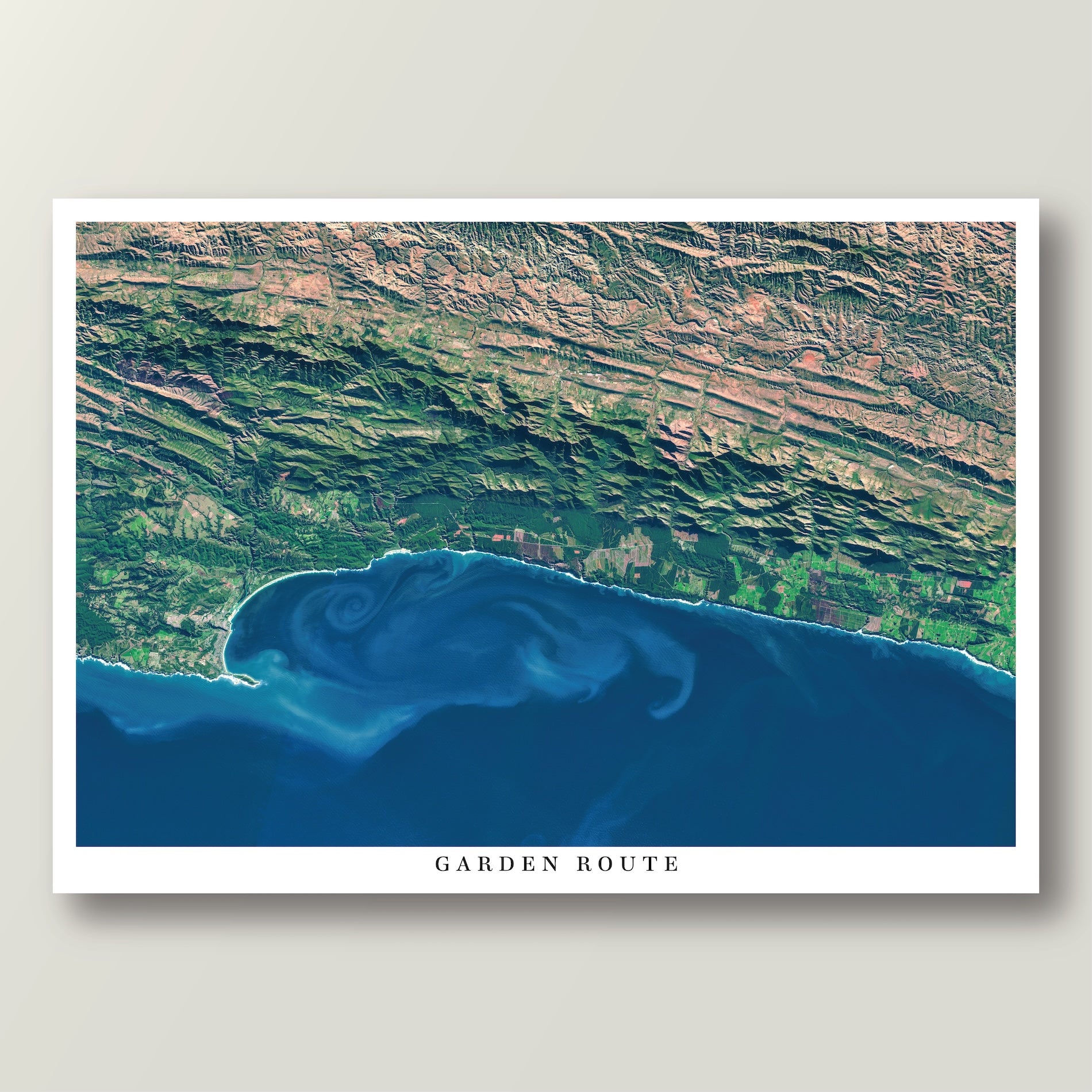 Garden Route 2 East satellite print in the Poster style, showing the coast from the Robberg Peninsula to the Tsitsikamma Mountains, with deep blue water and ocean currents, and the title Garden Route on the bottom white border