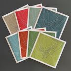 Fanned out display of Greyton maps in different colourways.